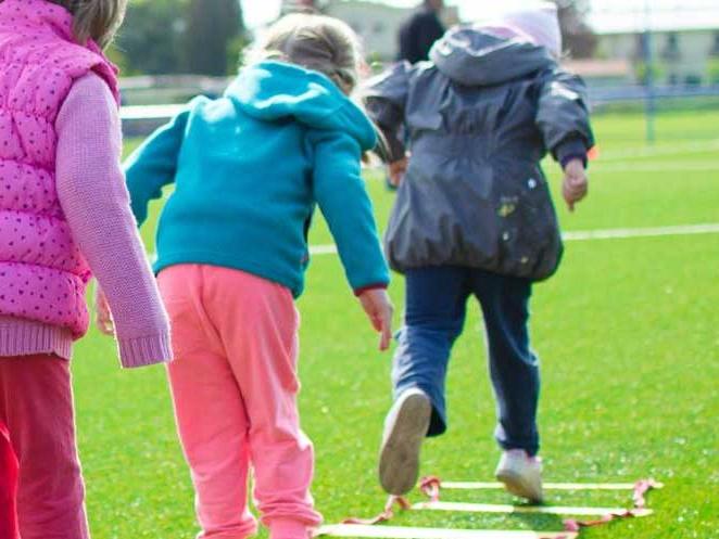 Young children doing ladder exercises