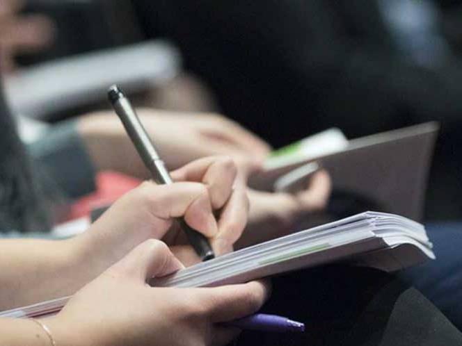 Student taking notes in a journal