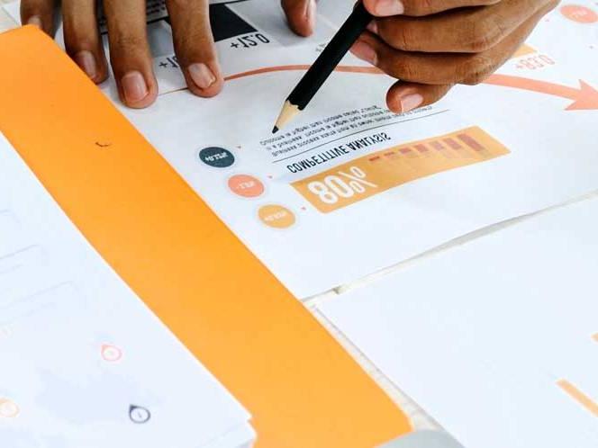 Student is hovering over information and graphs on a paper